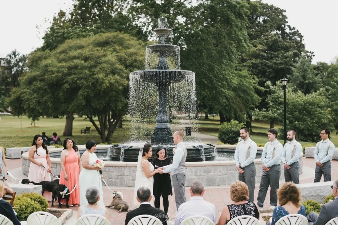 A park wedding ceremony beside a fountain