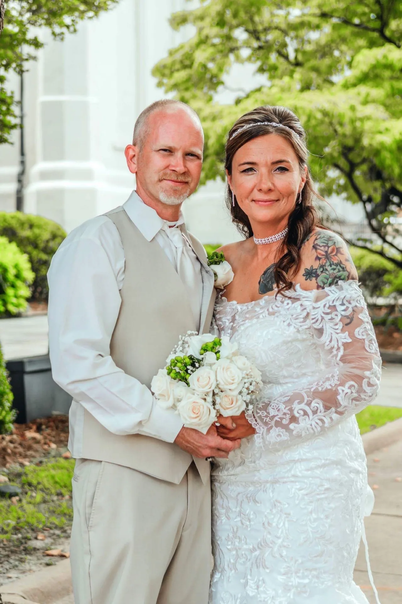 A couple outside a white-columned building