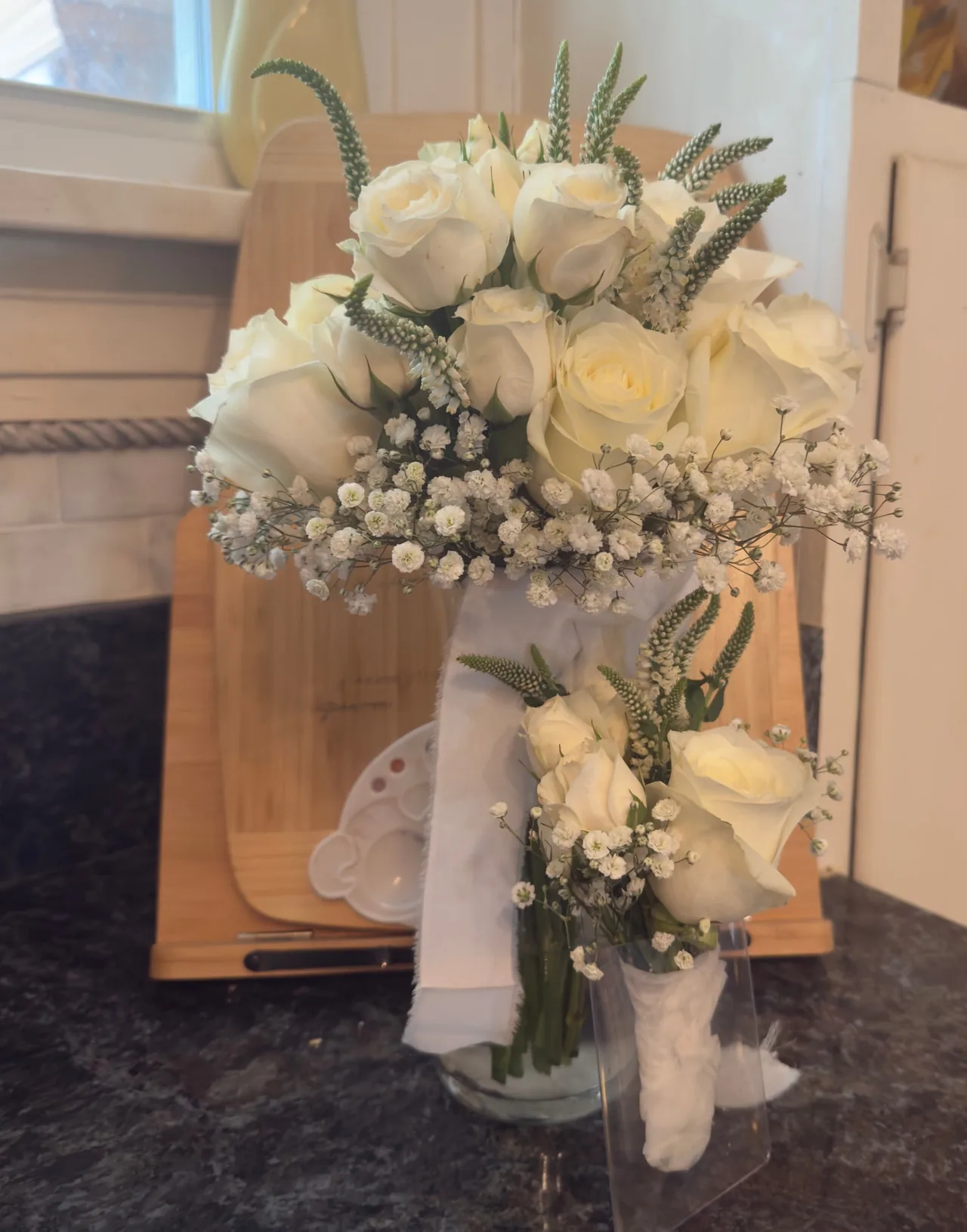 A white bouquet and matching boutonniere